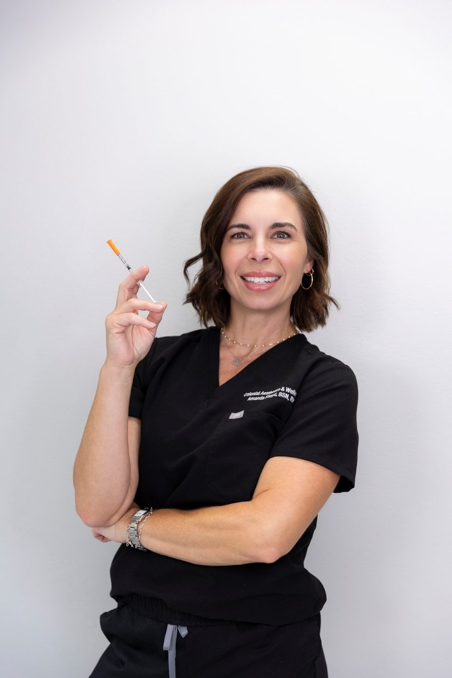Portrait of Amanda Floyd, BSN, RN — Aesthetic Nurse at Colonial Aesthetics & Wellness, holding an injectable syringe