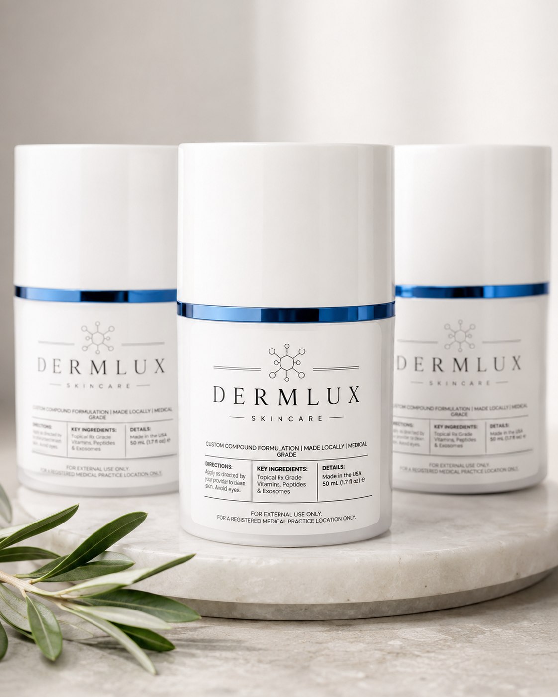 Three DermLux compounded skincare jars on a marble stand